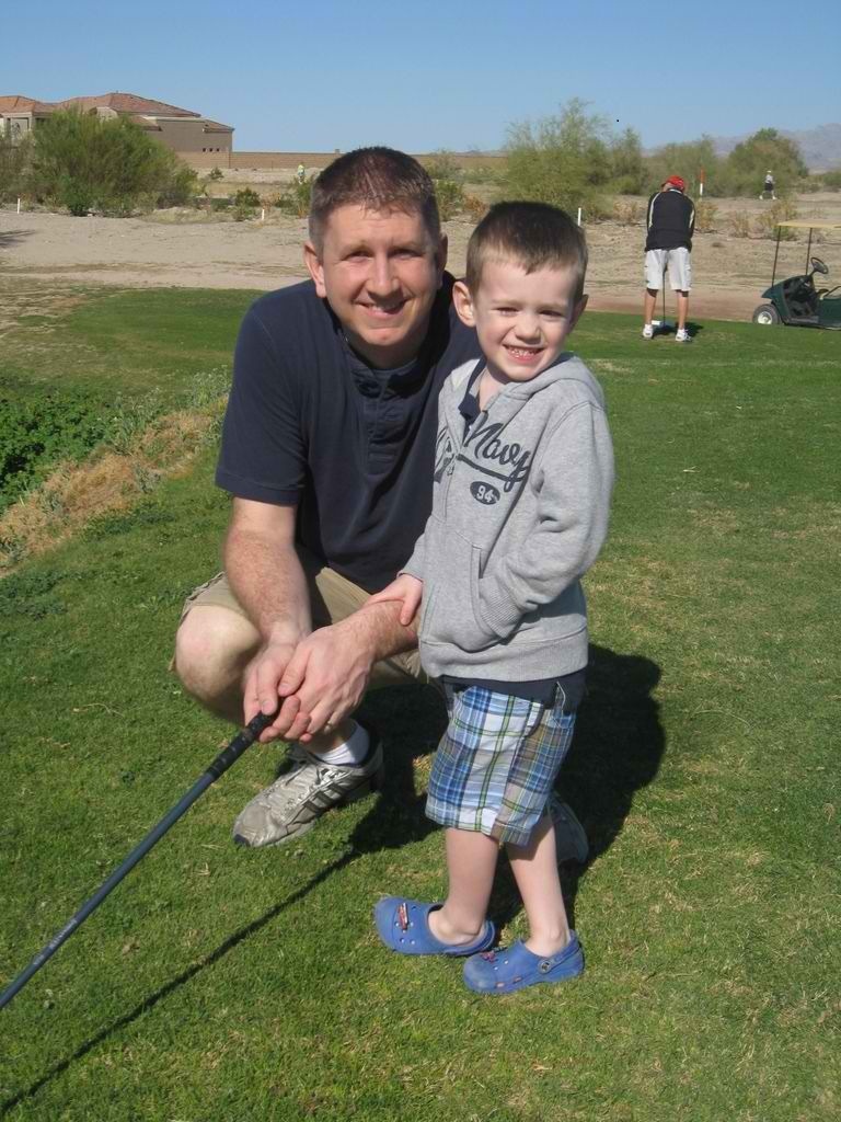 Son and father playing golf