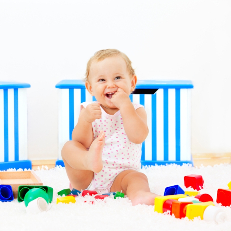 Baby girl playing with blocks