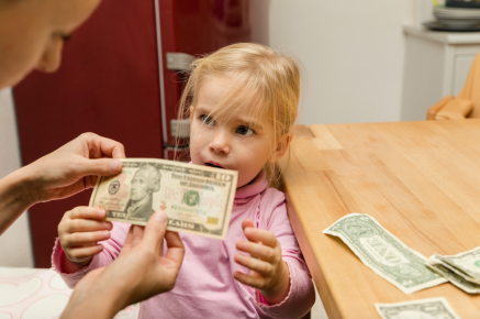Little girl receiving an allowance